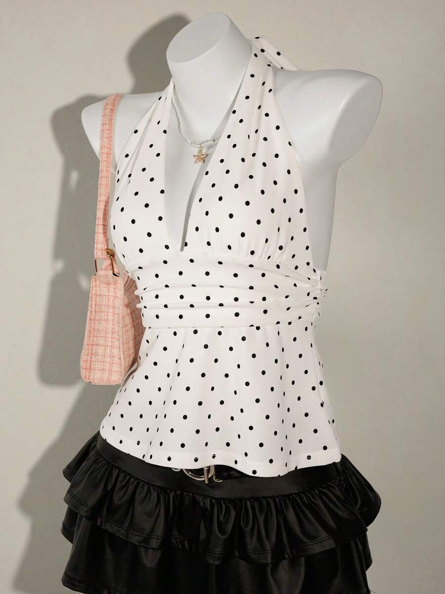White women's deep V-neck halter tank top with ruched waist, backless design, rib-knit texture, and ruffle hem