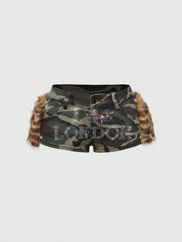 Army green Y2K K-pop style ultra low waist mini shorts with patchwork camo, star graphic details, rhinestone decoration, zipper fly, and pockets.