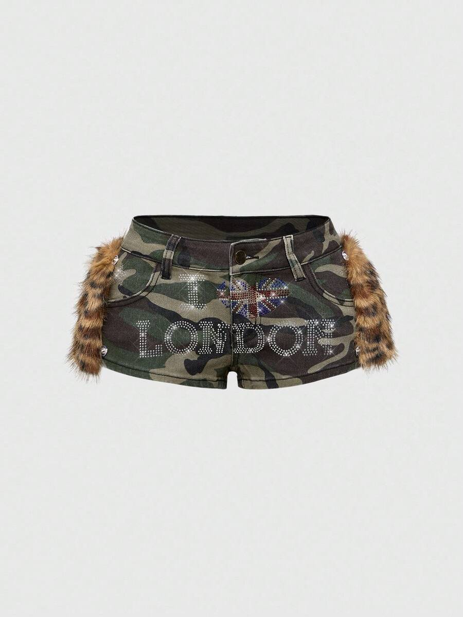 Army green Y2K K-pop style ultra low waist mini shorts with patchwork camo, star graphic details, rhinestone decoration, zipper fly, and pockets.