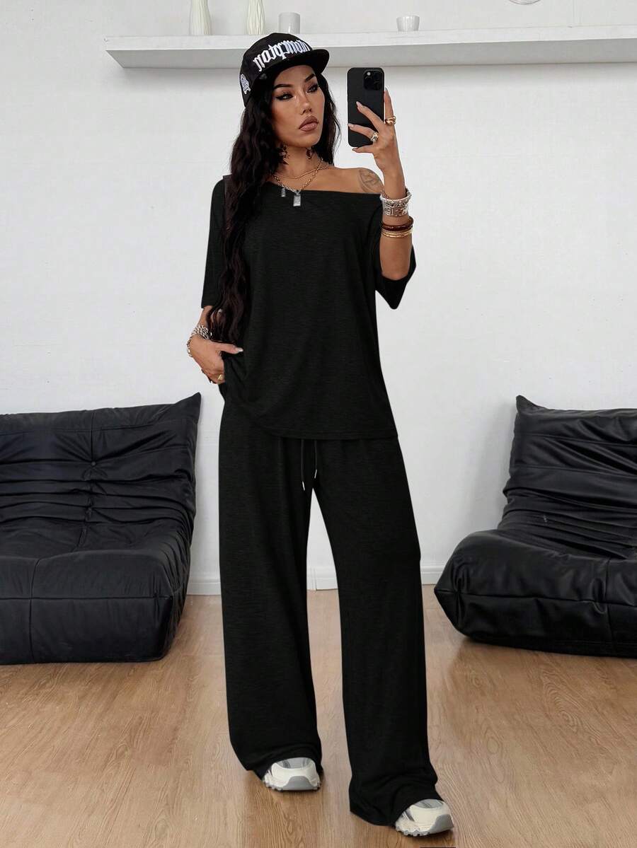 Women's two-piece outfit featuring an oversized asymmetrical neck t-shirt and matching wide-leg drawstring sweatpants.