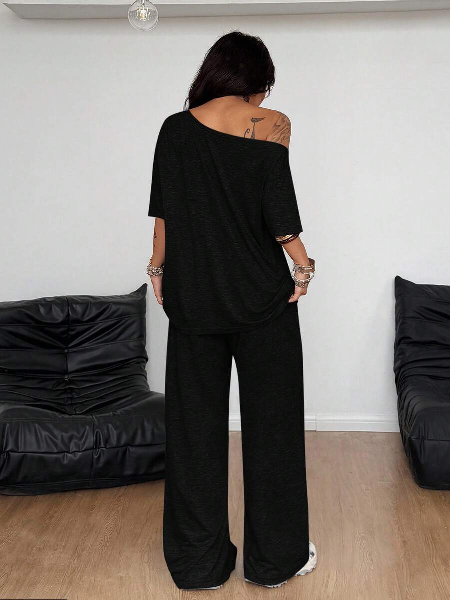 Women's two-piece outfit featuring an oversized asymmetrical neck t-shirt and matching wide-leg drawstring sweatpants.