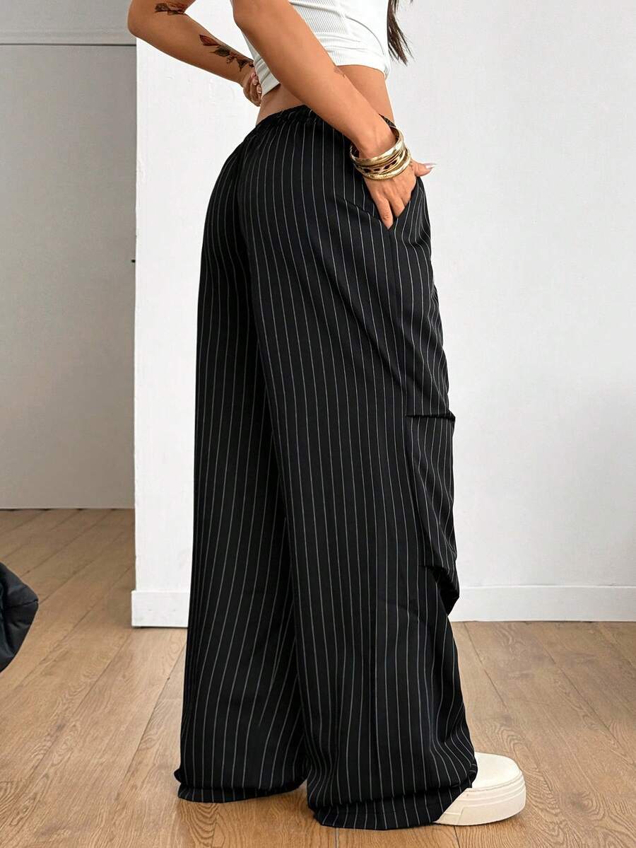 Women's black and white striped wide leg pants featuring an elastic drawstring waistband, side pockets, and a loose straight leg fit.