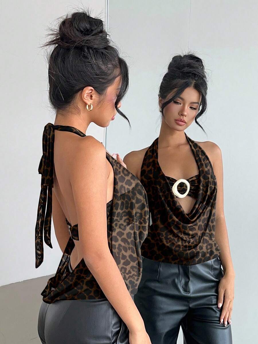 Brown and white polka dot semi-sheer halter camisole top with a plunging neckline, backless design, draped front, and metallic studded embellishments.