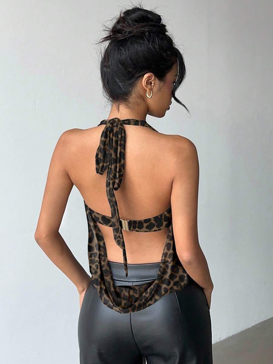 Brown and white polka dot semi-sheer halter camisole top with a plunging neckline, backless design, draped front, and metallic studded embellishments.