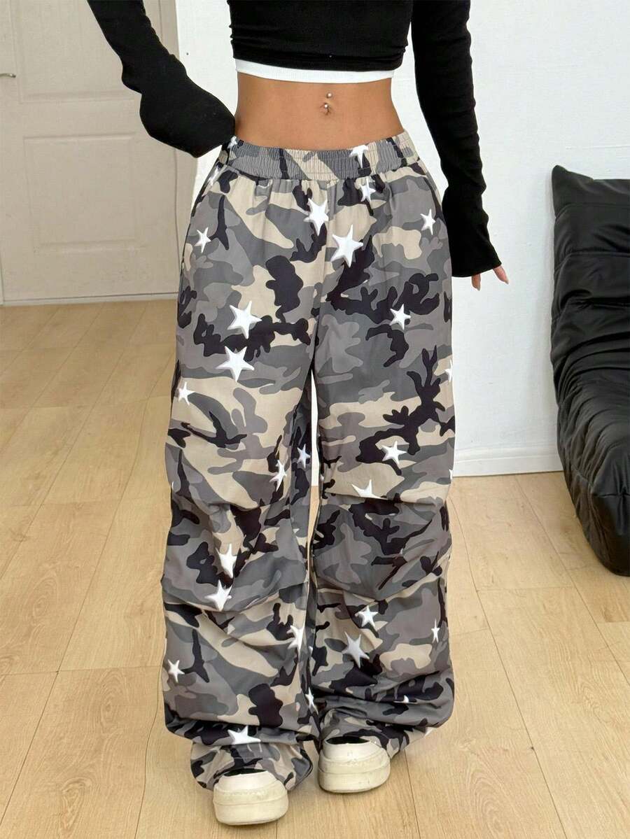 Women's black and white striped wide leg pants featuring an elastic drawstring waistband, side pockets, and a loose straight leg fit.