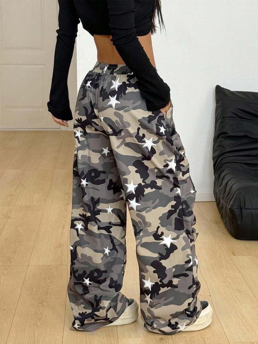 Women's black and white striped wide leg pants featuring an elastic drawstring waistband, side pockets, and a loose straight leg fit.