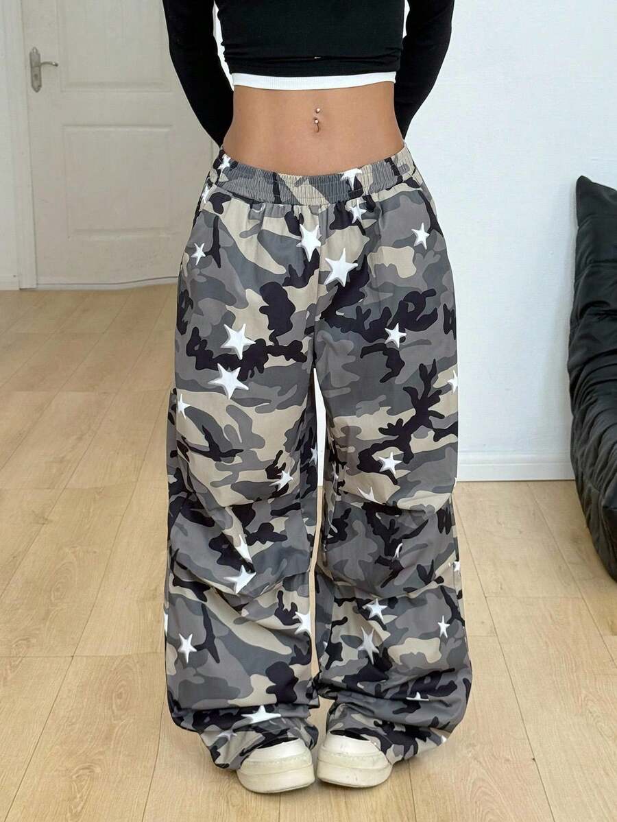 Women's black and white striped wide leg pants featuring an elastic drawstring waistband, side pockets, and a loose straight leg fit.