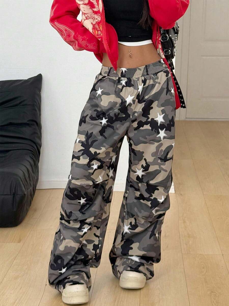 Women's black and white striped wide leg pants featuring an elastic drawstring waistband, side pockets, and a loose straight leg fit.