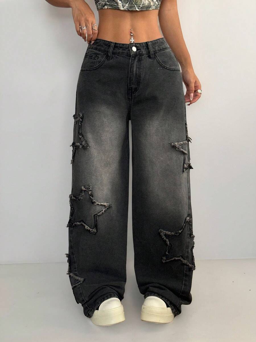 Plus size women's black wide leg denim jeans featuring a mid-waist cut, zipper fly, and distressed ripped detailing.
