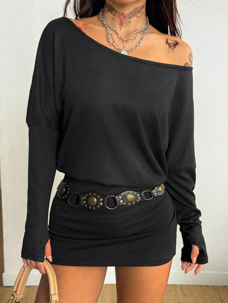 Women's long sleeve bodycon mini dress in black knitted fabric with an asymmetrical neckline and ruched accents.