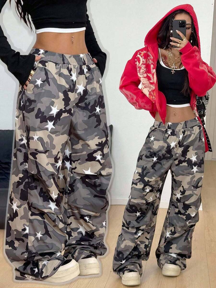 Women's black and white striped wide leg pants featuring an elastic drawstring waistband, side pockets, and a loose straight leg fit.