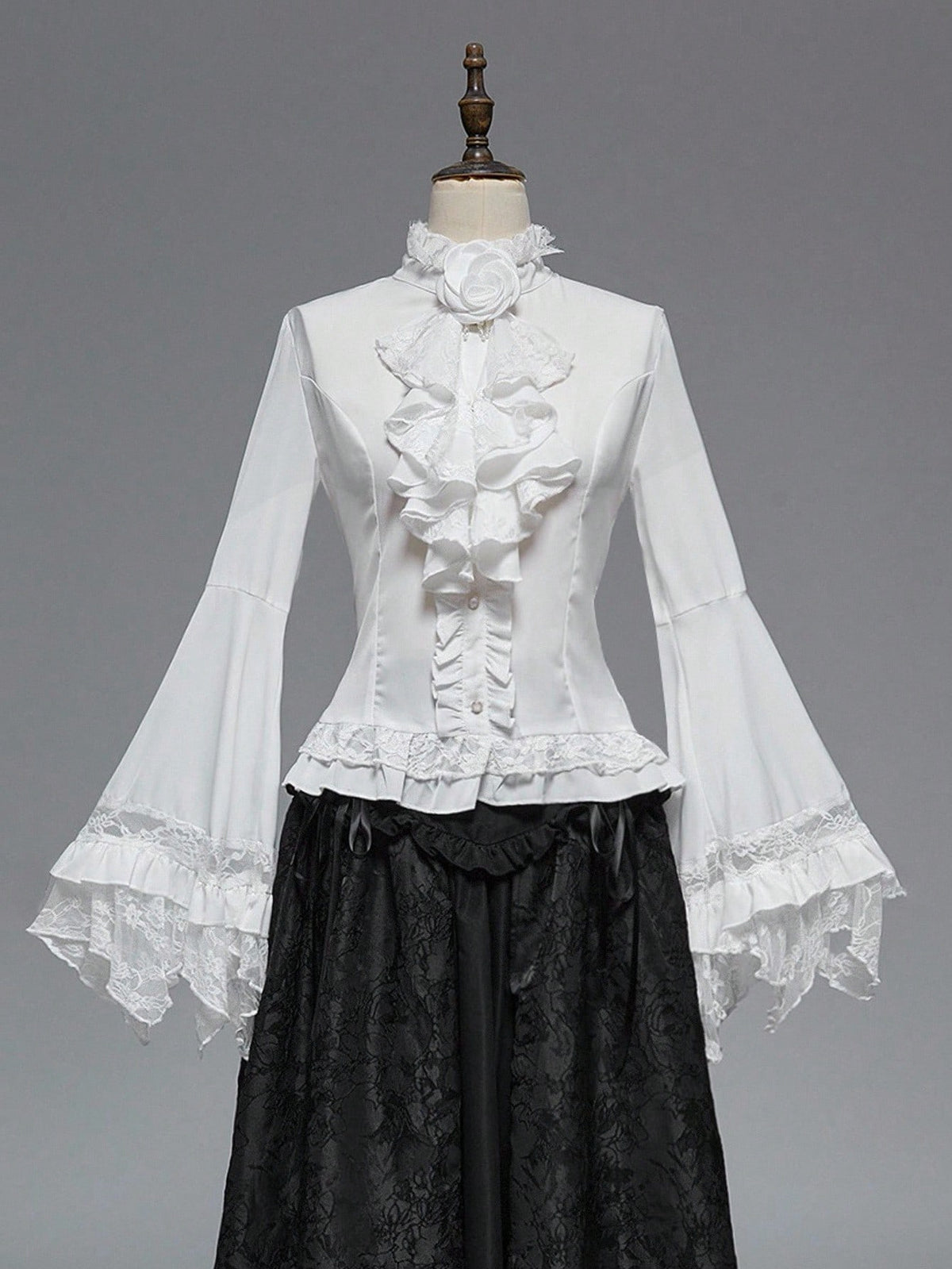 Women's gothic lace blouse with flare long sleeves, tie neckline, and semi-sheer embroidery details.