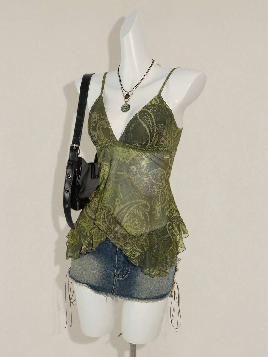 Women's graphic print camisole top featuring thin spaghetti straps, a backless cut, and an asymmetrical hem.
