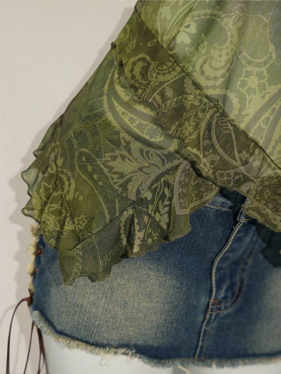 Women's graphic print camisole top featuring thin spaghetti straps, a backless cut, and an asymmetrical hem.