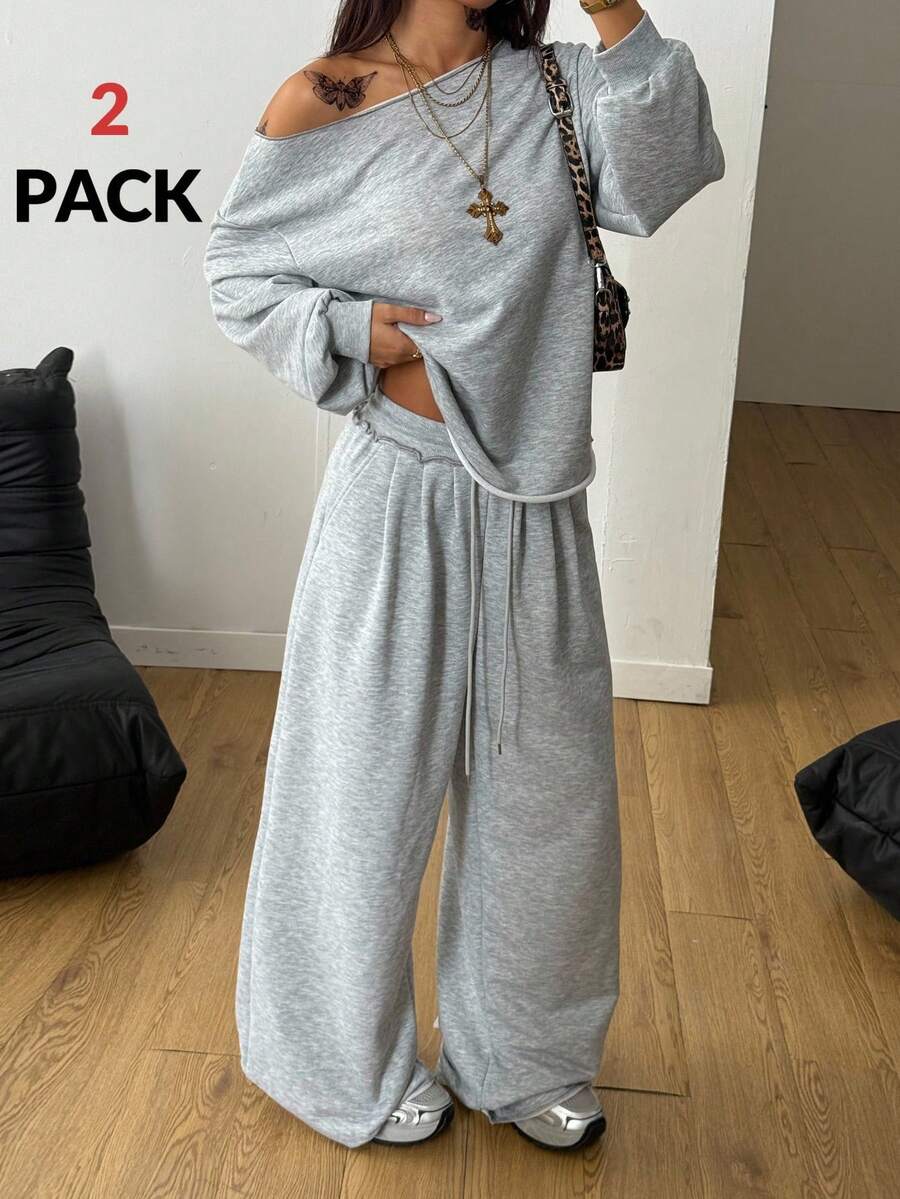 Women's two-piece casual lounge set featuring a loose drop-shoulder long sleeve sweatshirt and high-waist drawstring sweatpants with pockets.