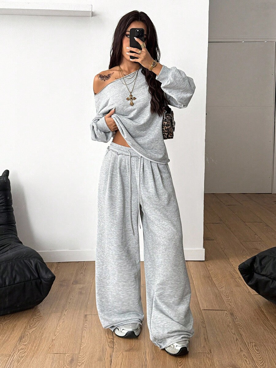 Women's two-piece casual lounge set featuring a loose drop-shoulder long sleeve sweatshirt and high-waist drawstring sweatpants with pockets.
