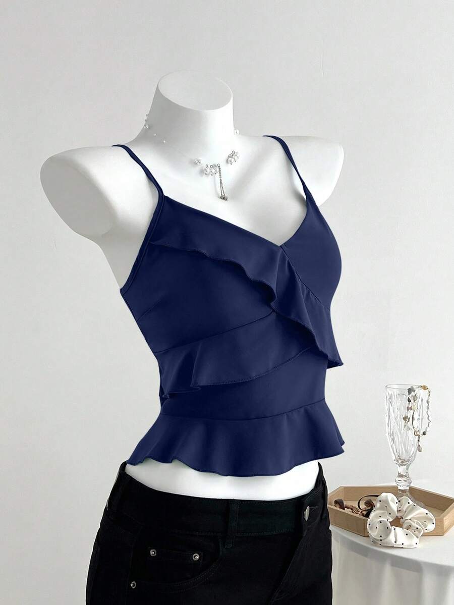 Women's solid color camisole top with thin spaghetti straps, tiered layers, and a flared ruffled hem.