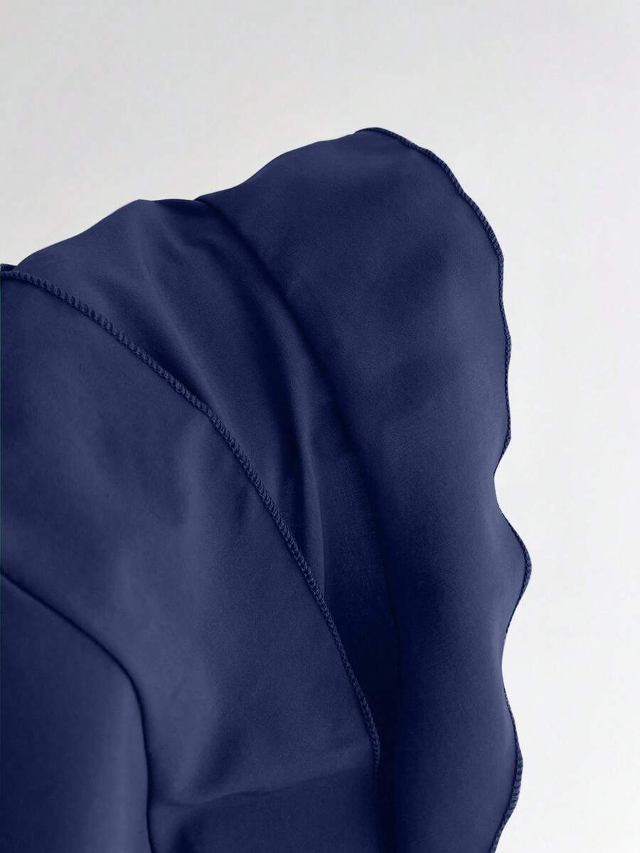 Women's solid color camisole top with thin spaghetti straps, tiered layers, and a flared ruffled hem.