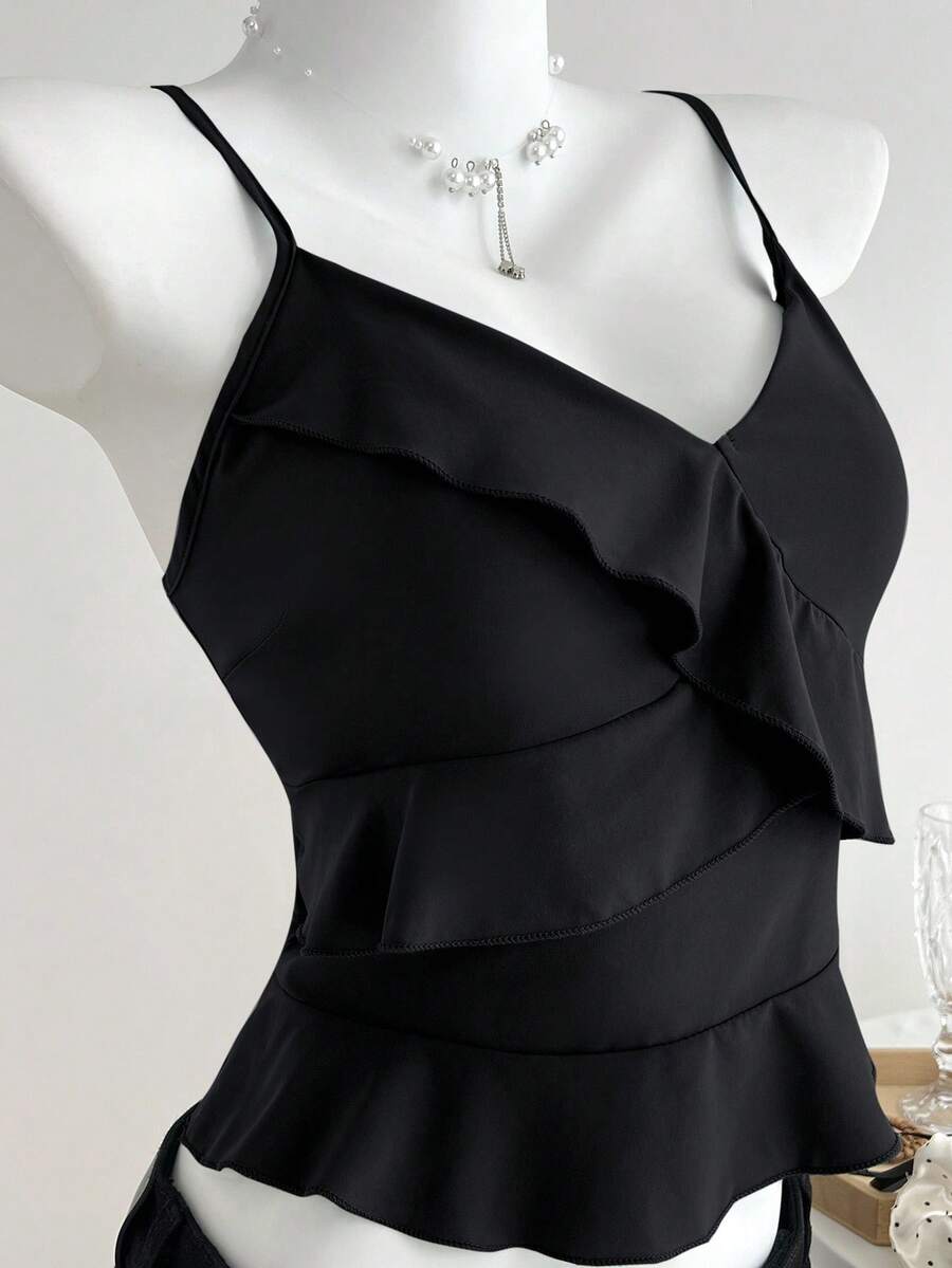 Women's solid color camisole top with thin spaghetti straps, tiered layers, and a flared ruffled hem.