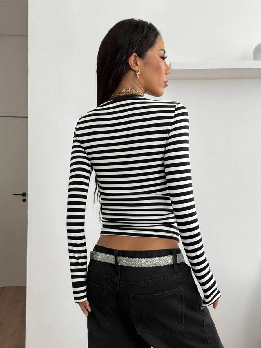 Women's slim fit long sleeve t-shirt with a deep V-neck cut from stretchy knit fabric.