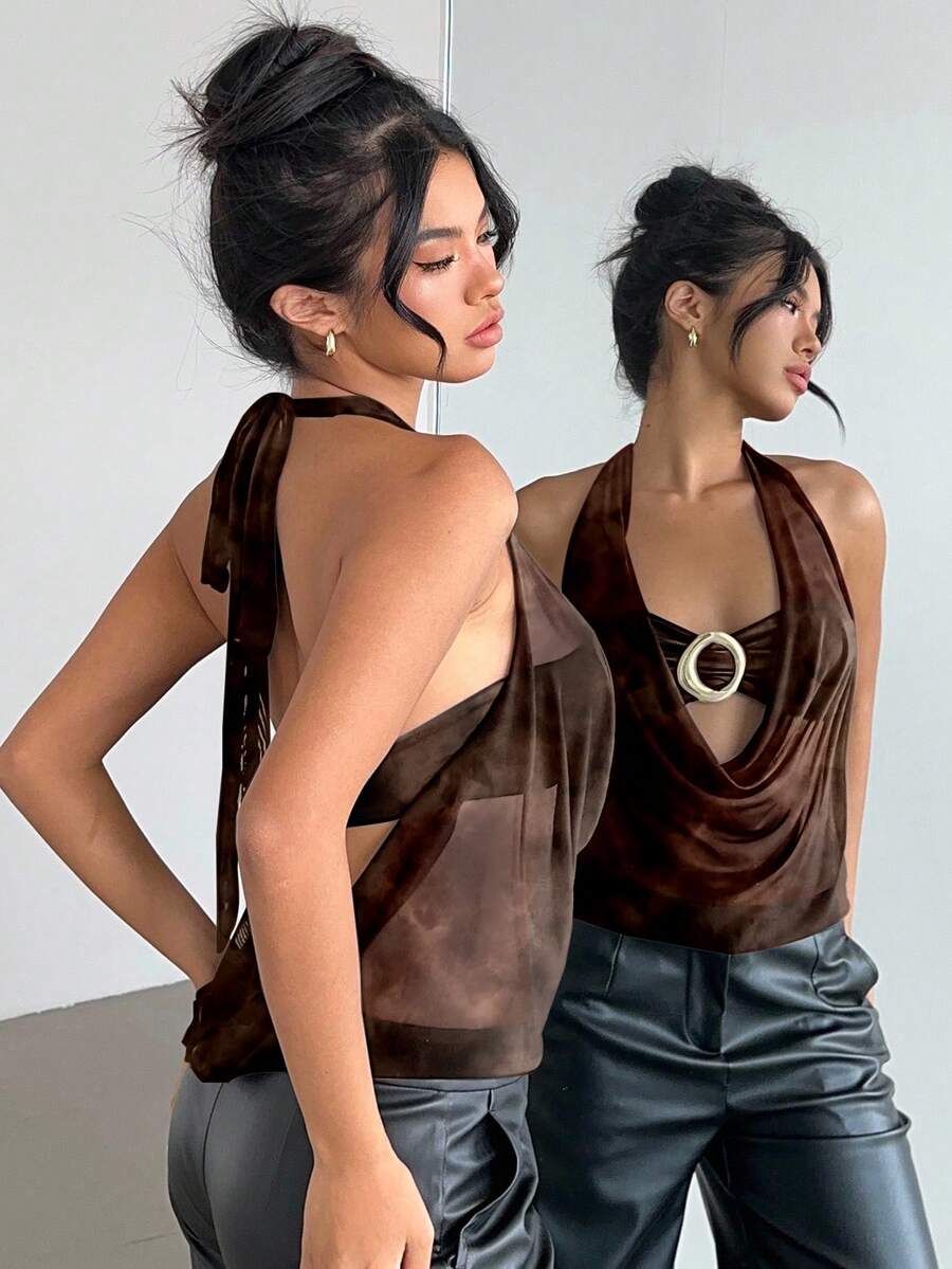 Brown and white polka dot semi-sheer halter camisole top with a plunging neckline, backless design, draped front, and metallic studded embellishments.