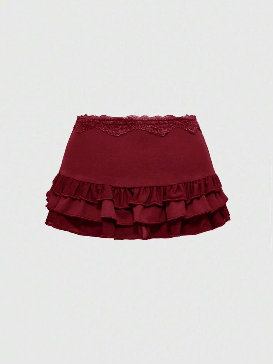 Women's black low-waist mini skirt with drawstring tie, ruched details, lace trim, layered ruffle hem, and asymmetric styling