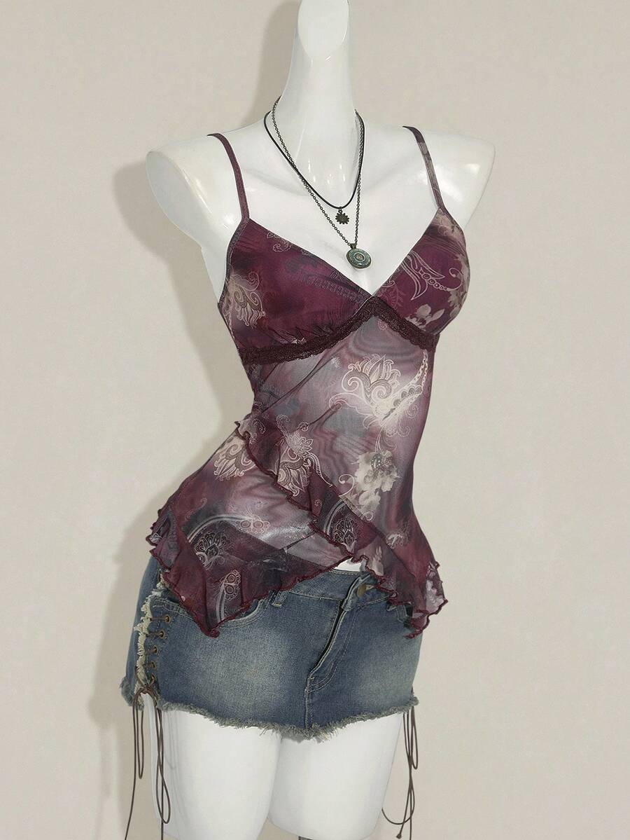 Women's graphic print camisole top featuring thin spaghetti straps, a backless cut, and an asymmetrical hem.