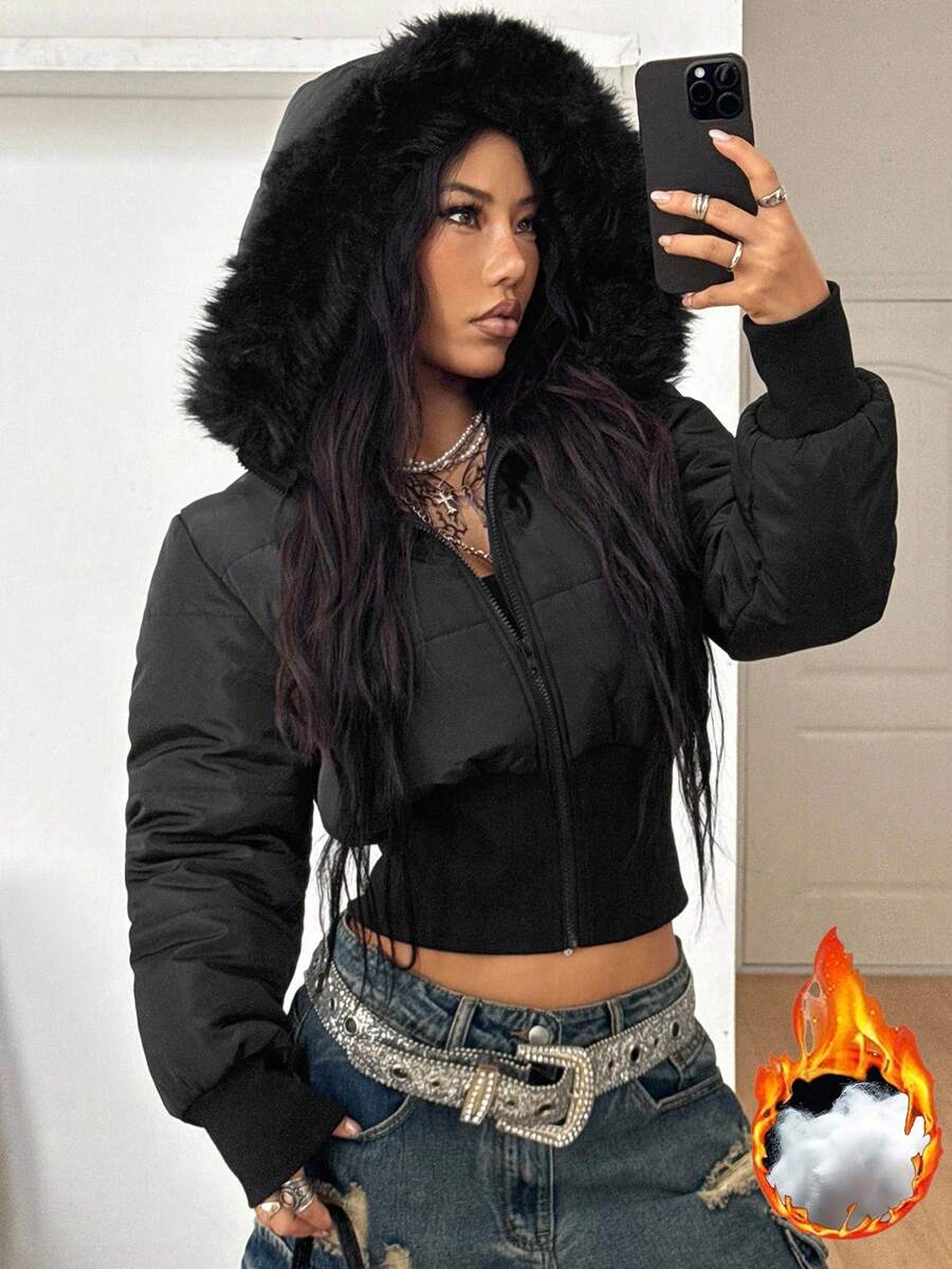 Women's brown cropped puffer jacket featuring a faux fur trimmed hood, front zipper, and ribbed hem.