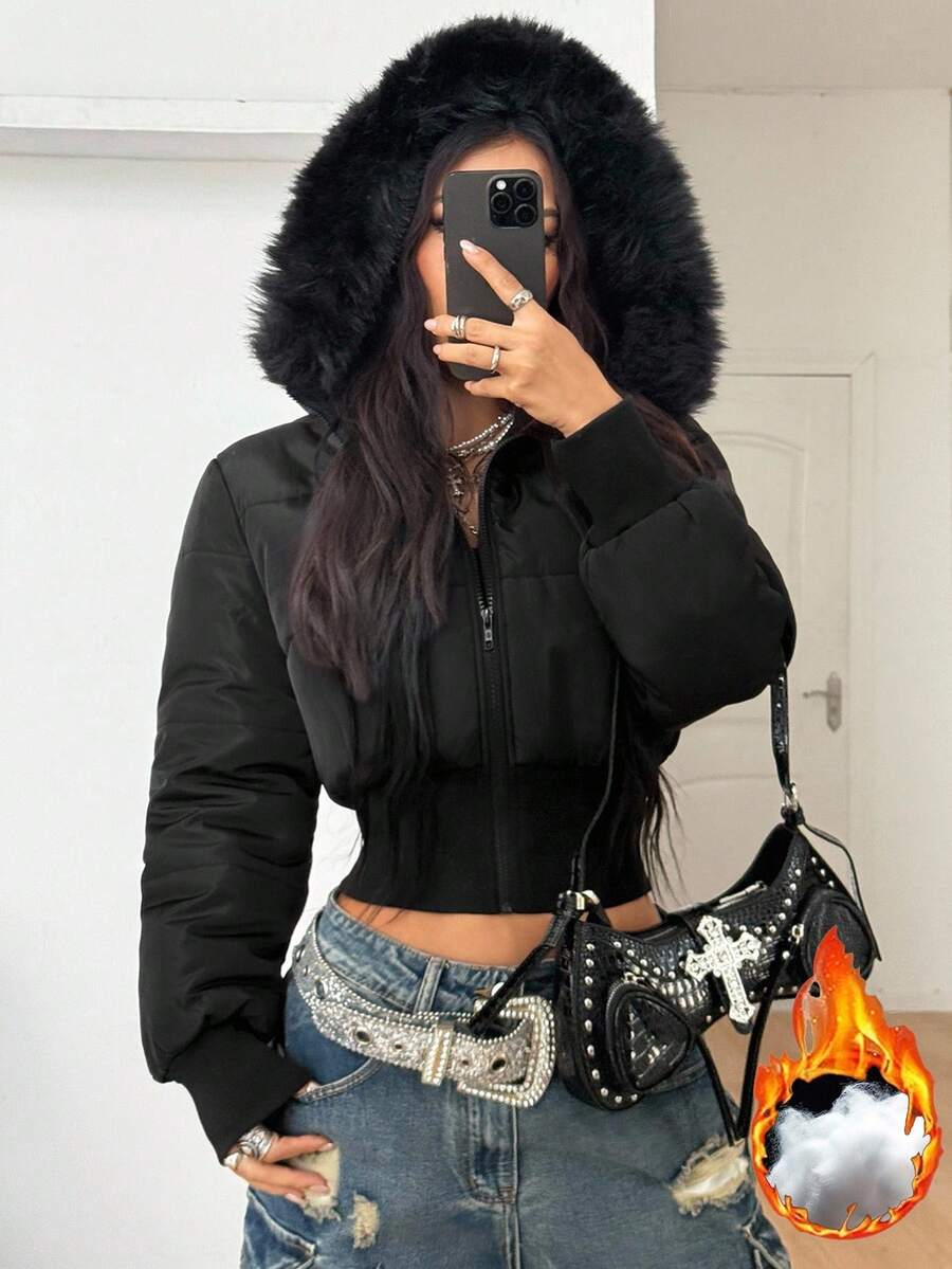Women's brown cropped puffer jacket featuring a faux fur trimmed hood, front zipper, and ribbed hem.