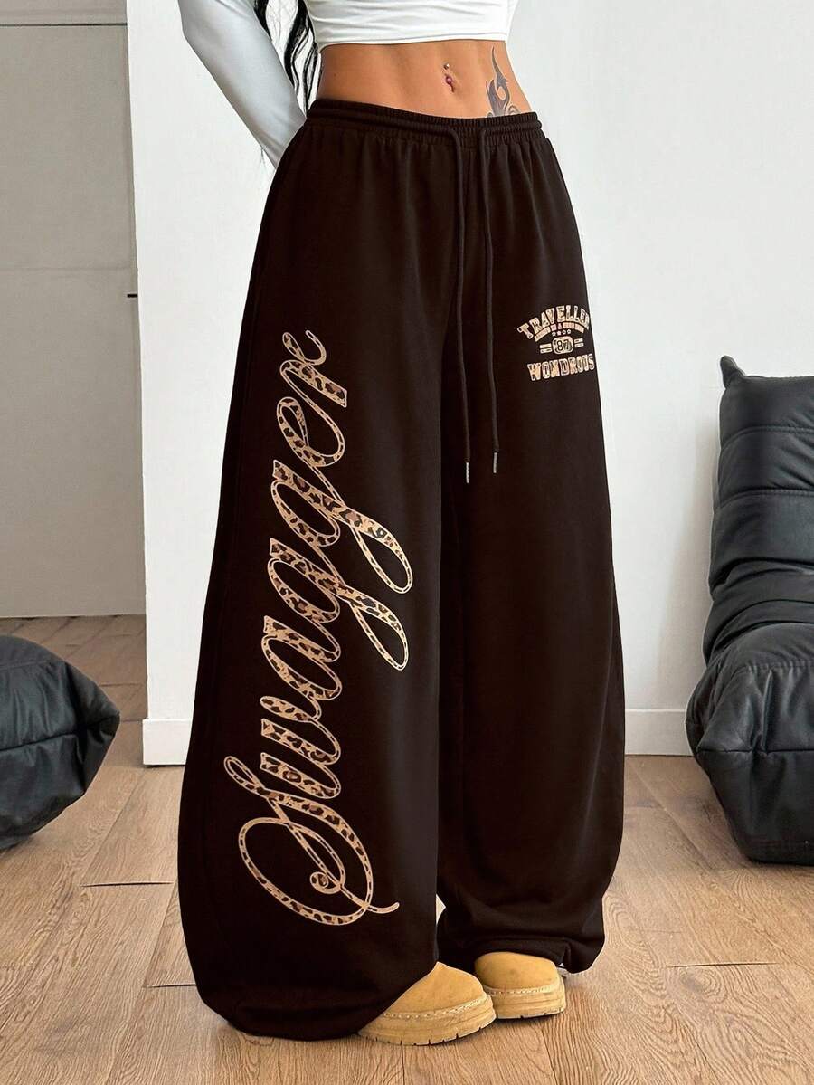 Women's loose fit wide leg graphic sweatpants in light grey with an elastic drawstring waistband