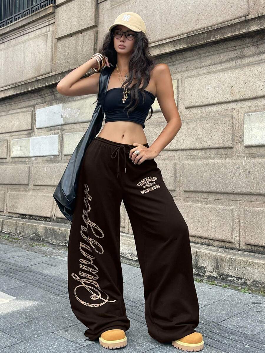 Women's loose fit wide leg graphic sweatpants in light grey with an elastic drawstring waistband