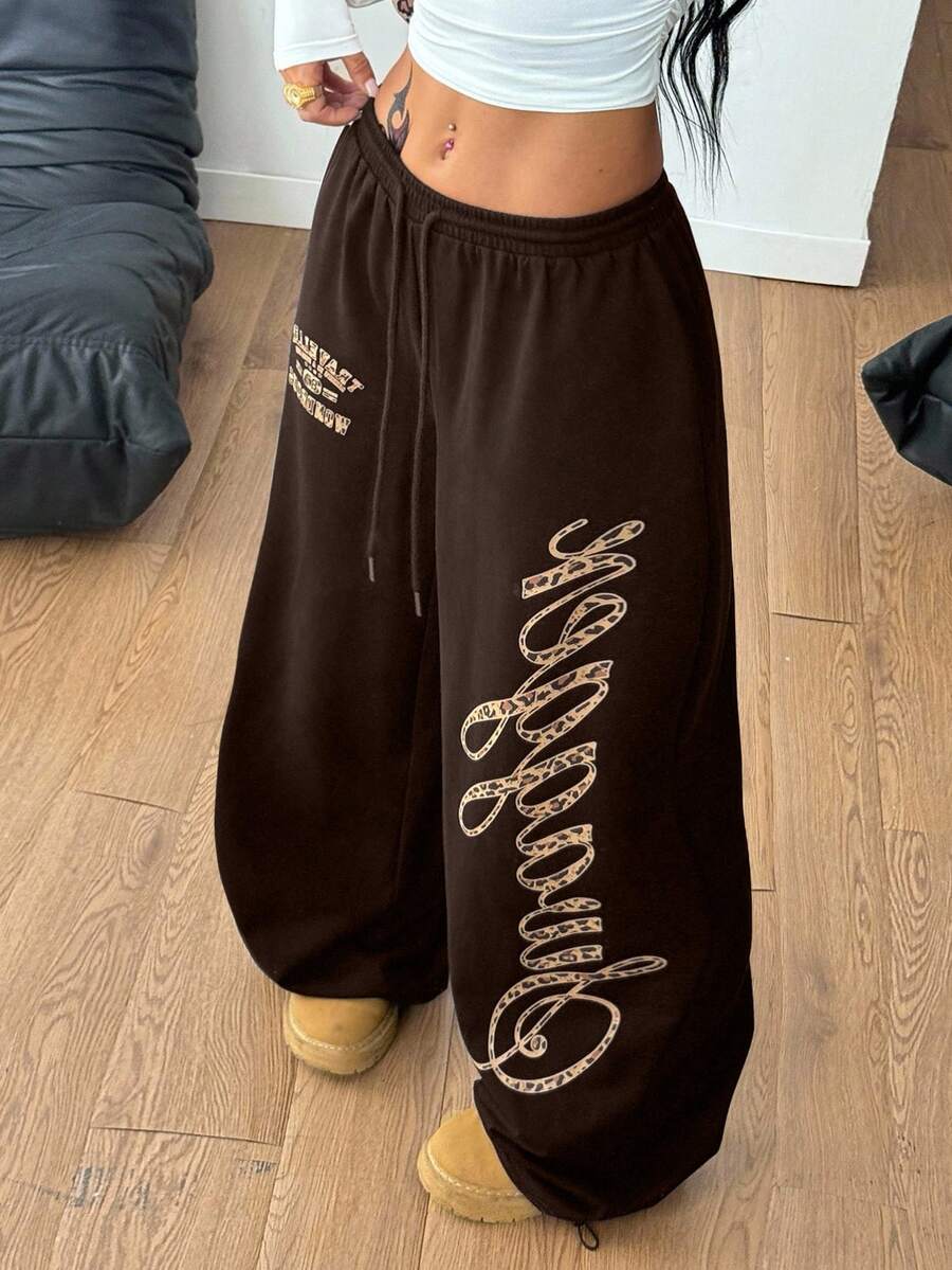 Women's loose fit wide leg graphic sweatpants in light grey with an elastic drawstring waistband