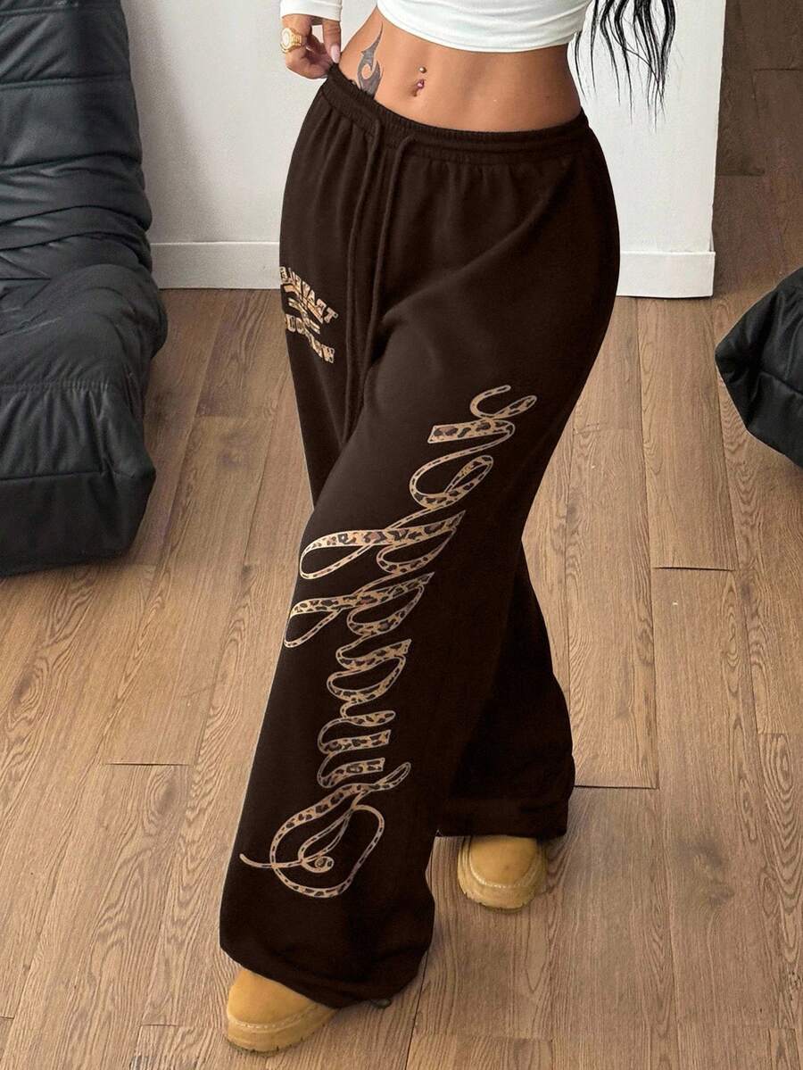 Women's loose fit wide leg graphic sweatpants in light grey with an elastic drawstring waistband