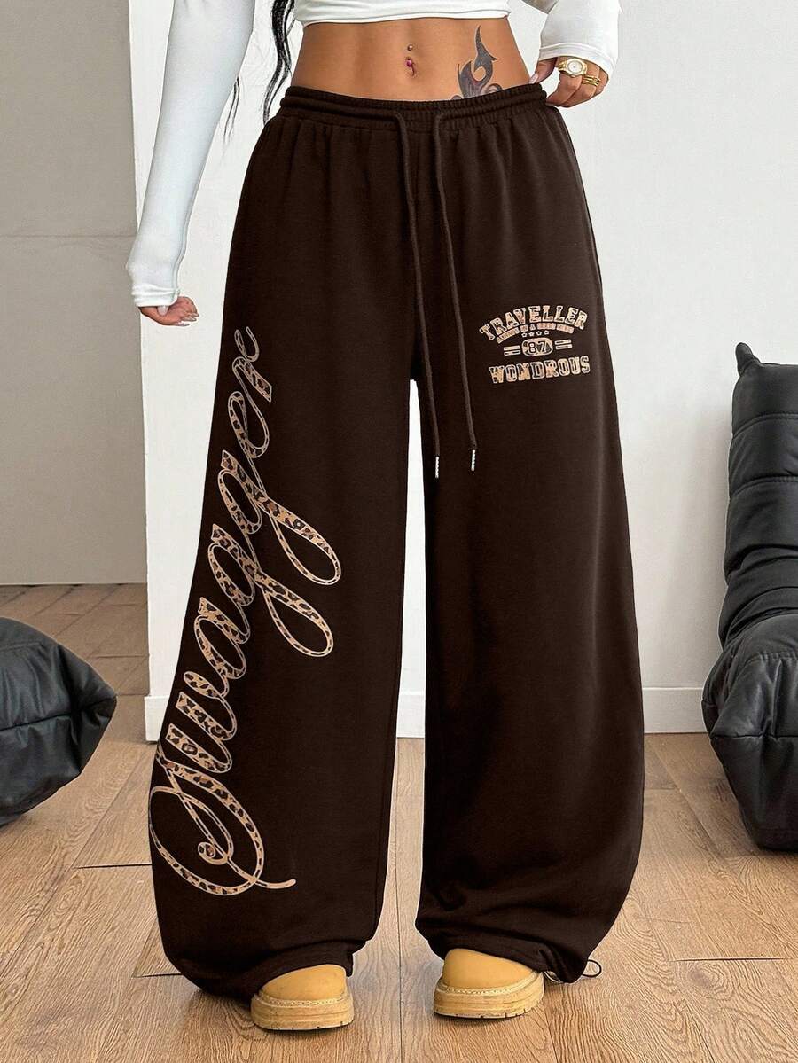 Women's loose fit wide leg graphic sweatpants in light grey with an elastic drawstring waistband