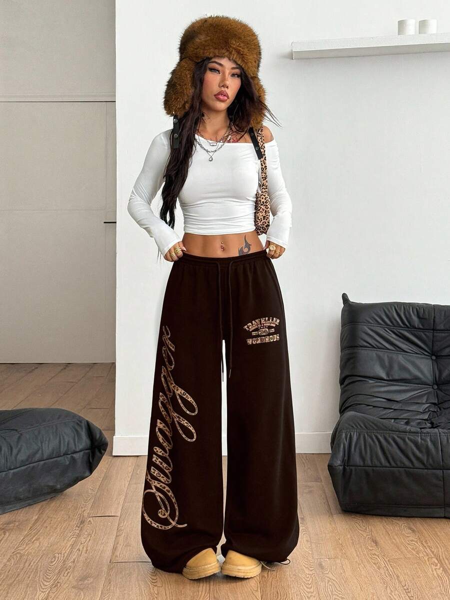 Women's loose fit wide leg graphic sweatpants in light grey with an elastic drawstring waistband