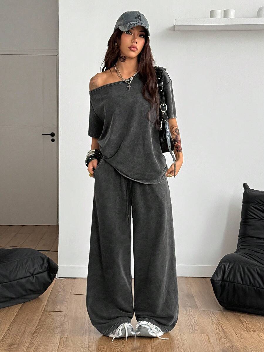 Women's two-piece outfit featuring an oversized asymmetrical neck t-shirt and matching wide-leg drawstring sweatpants.