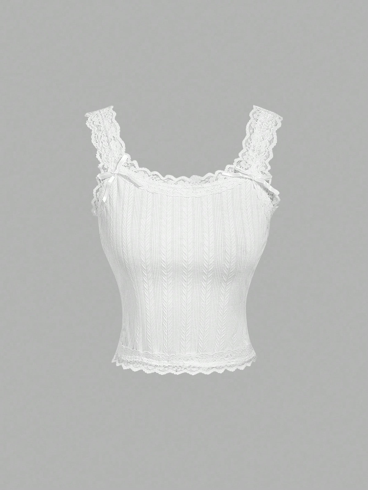 Black jacquard textured camisole top featuring contrast lace trim, bow decoration, scoop neck, and wide shoulder straps.