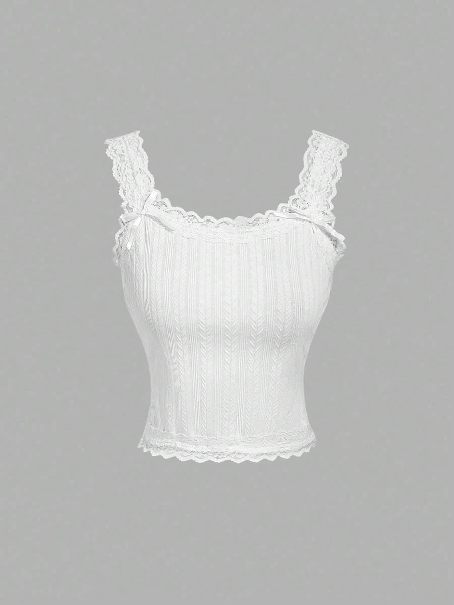 Black jacquard textured camisole top featuring contrast lace trim, bow decoration, scoop neck, and wide shoulder straps.