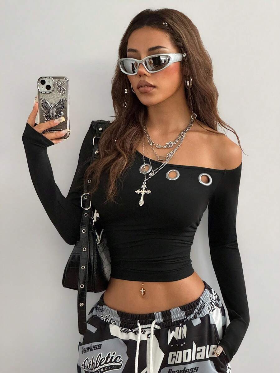 Women's slim fit long sleeve knit top featuring an asymmetrical neckline and grommet eyelet detail