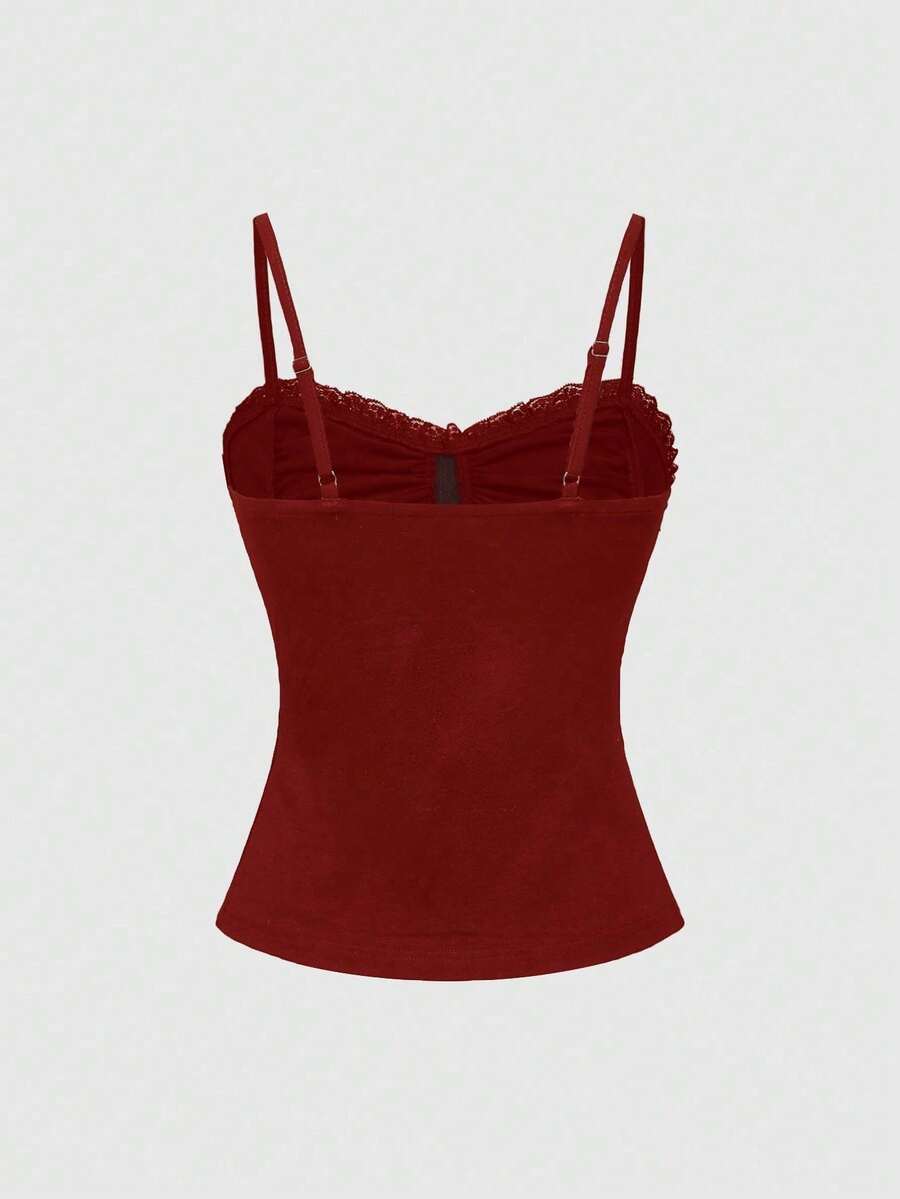 Black gothic spaghetti strap tank top for women featuring contrast lace patchwork, ruched frill details, and a cross pendant accent in a slim fit knitted fabric.