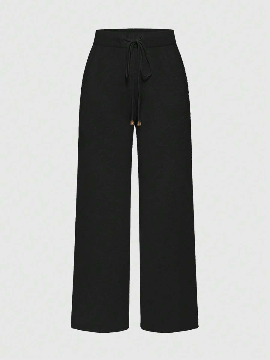 Women's two-piece rib-knit sweater set featuring a long-sleeve cold-shoulder crop top with strap details and matching wide-leg pants.