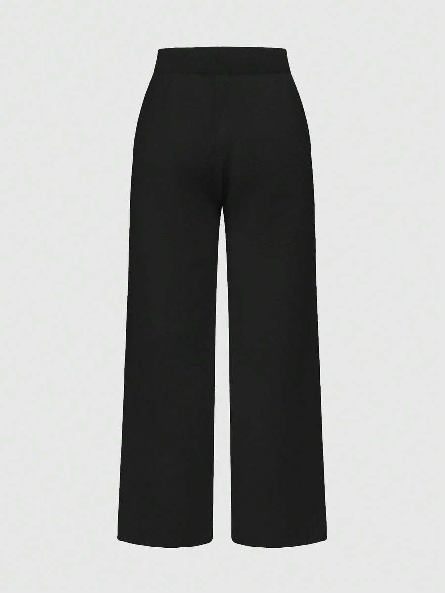 Women's two-piece rib-knit sweater set featuring a long-sleeve cold-shoulder crop top with strap details and matching wide-leg pants.