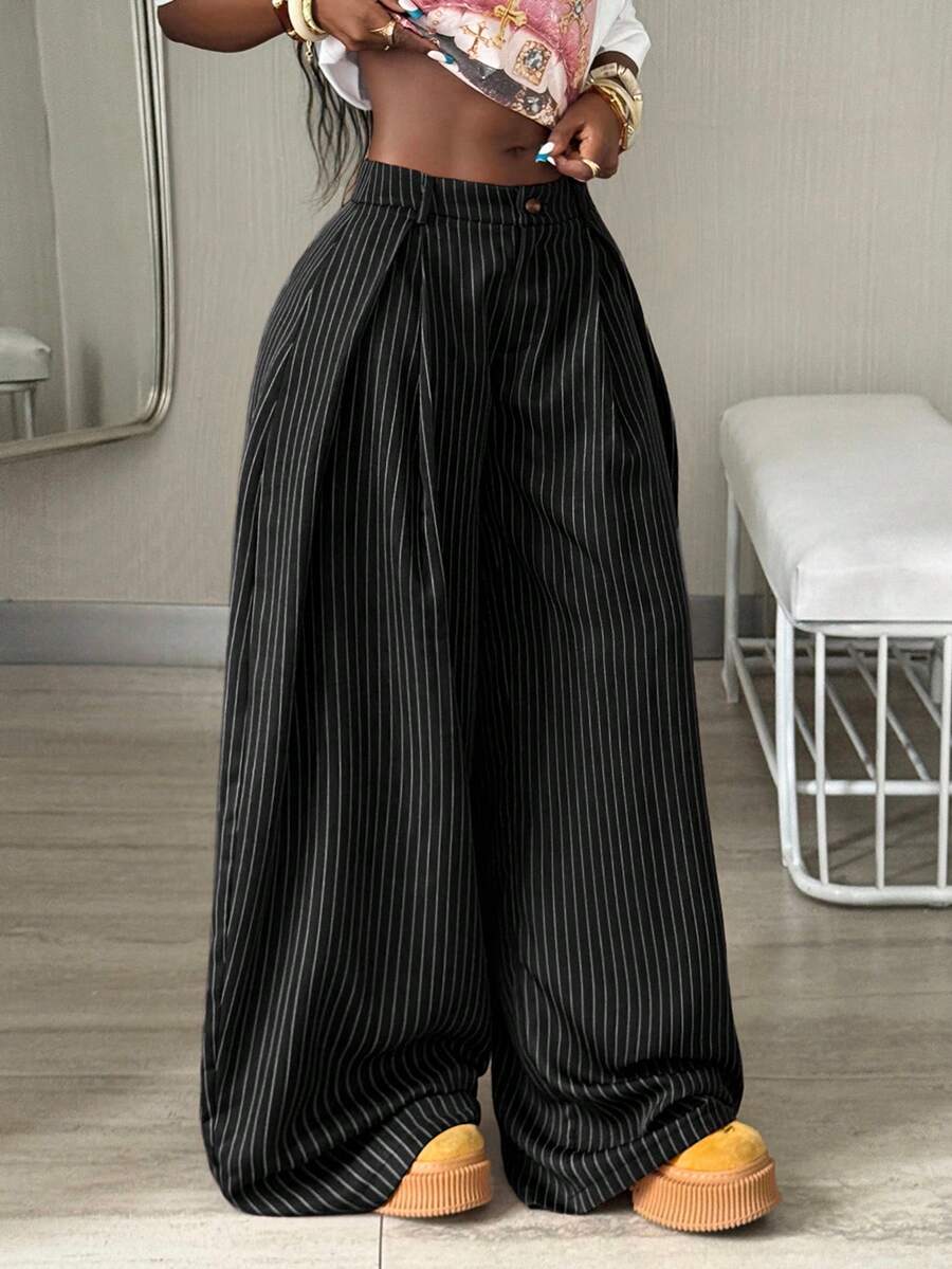 Women's brown striped wide leg pants with a low waist, curved hem, and loose casual fit in woven fabric.
