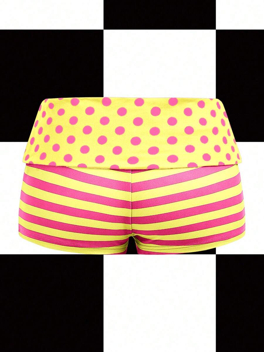 Women's black low waist mini track shorts with contrast polka dot, striped, geometric, and plant-inspired print details, elastic waistband, and skinny fit