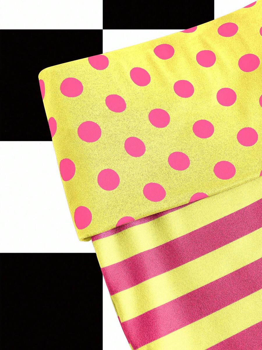 Women's black low waist mini track shorts with contrast polka dot, striped, geometric, and plant-inspired print details, elastic waistband, and skinny fit