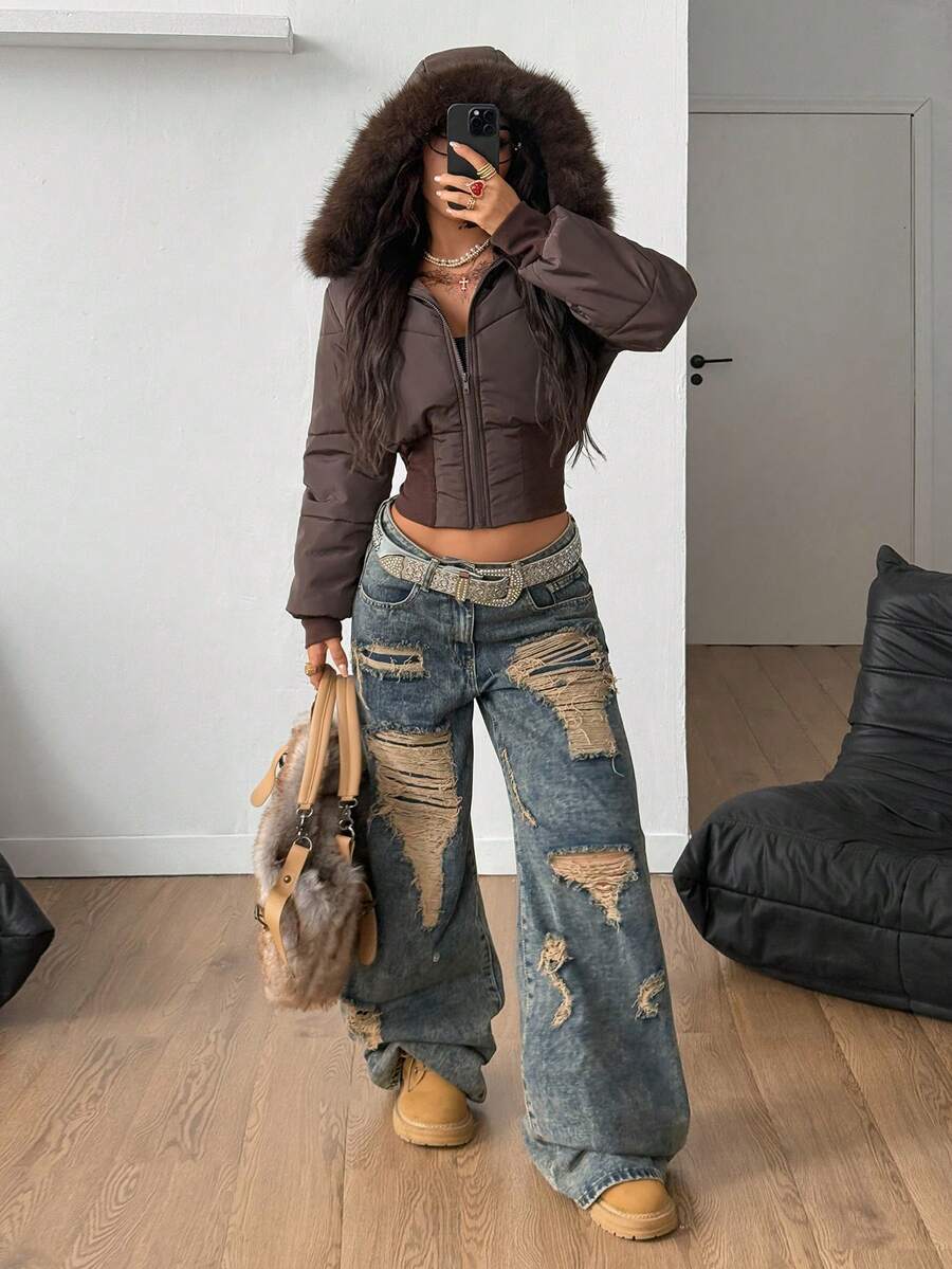 Women's brown cropped puffer jacket featuring a faux fur trimmed hood, front zipper, and ribbed hem.