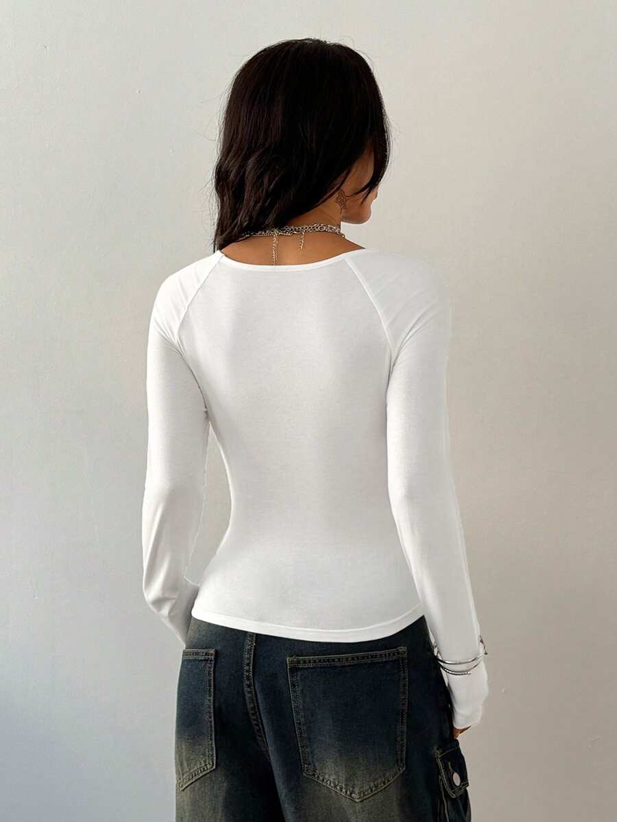 Women's slim fit long sleeve raglan t-shirt with collegiate letter graphic print, round neck, and contrast binding.