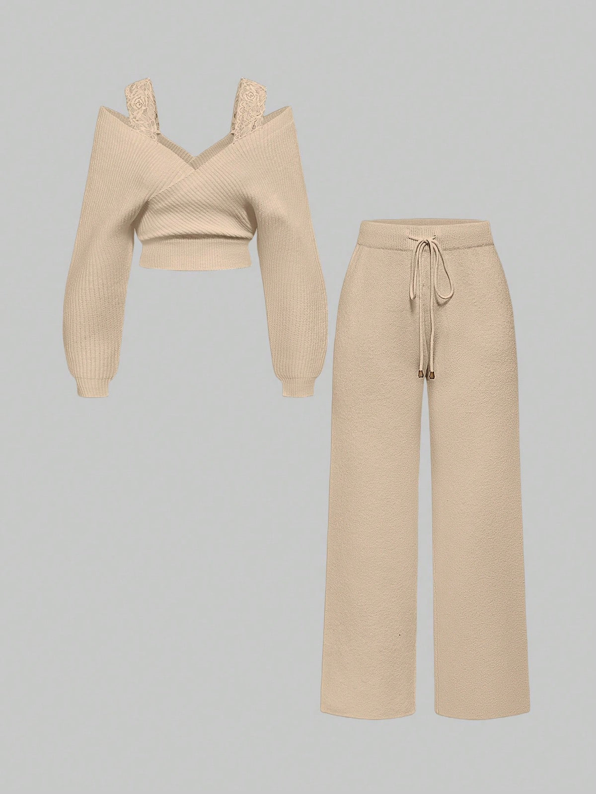 Women's two-piece rib-knit sweater set featuring a long-sleeve cold-shoulder crop top with strap details and matching wide-leg pants.