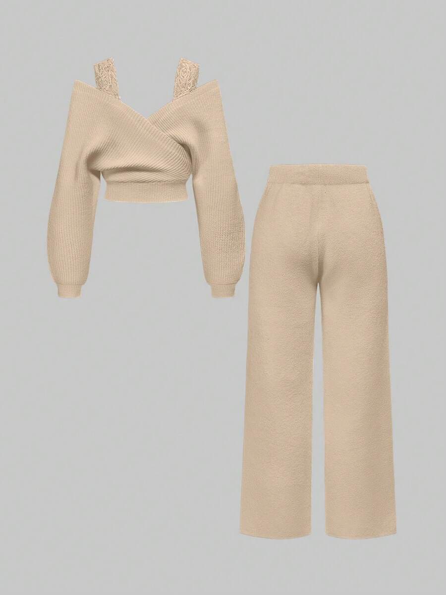 Women's two-piece rib-knit sweater set featuring a long-sleeve cold-shoulder crop top with strap details and matching wide-leg pants.