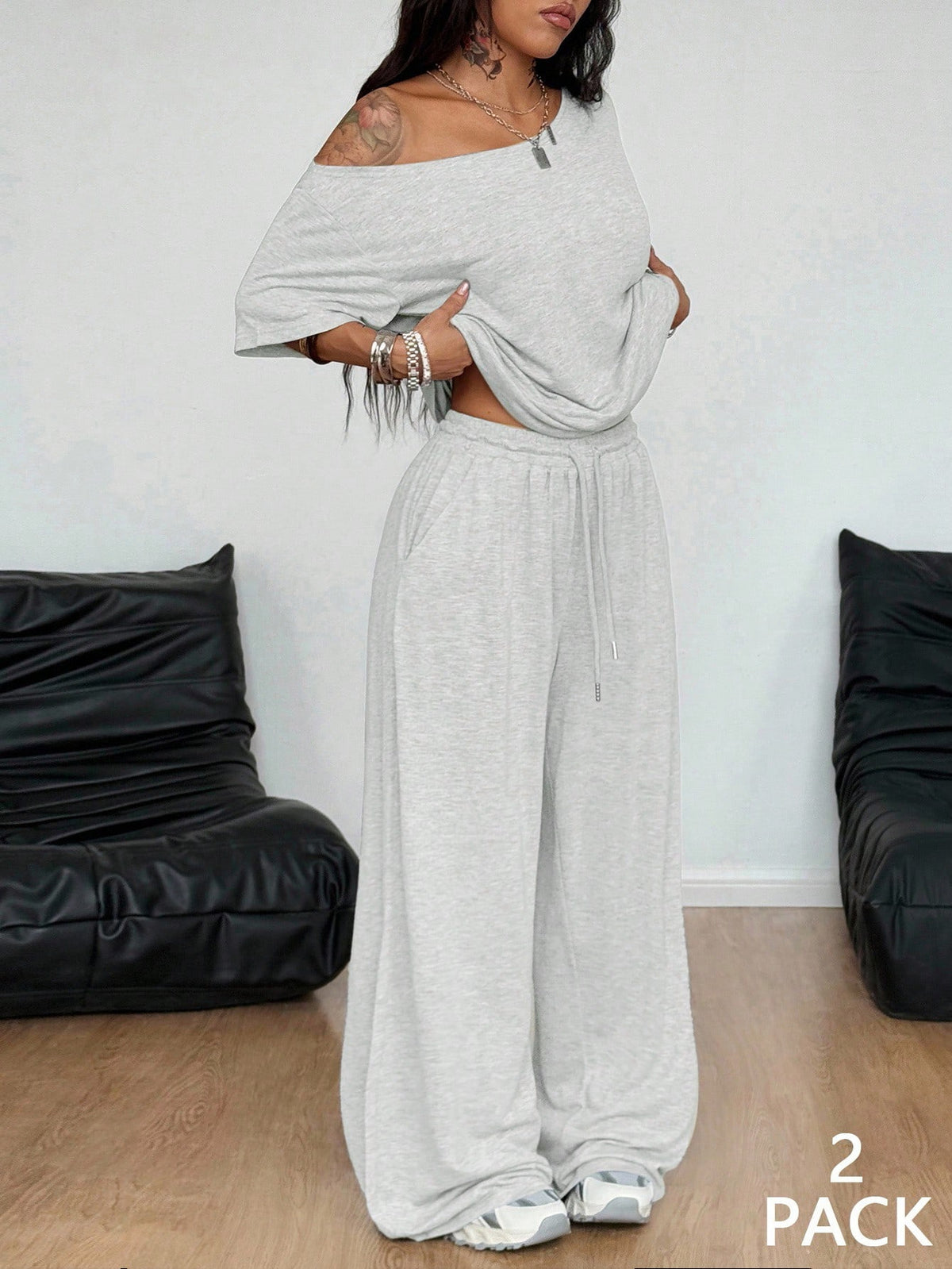 Women's two-piece outfit featuring an oversized asymmetrical neck t-shirt and matching wide-leg drawstring sweatpants.